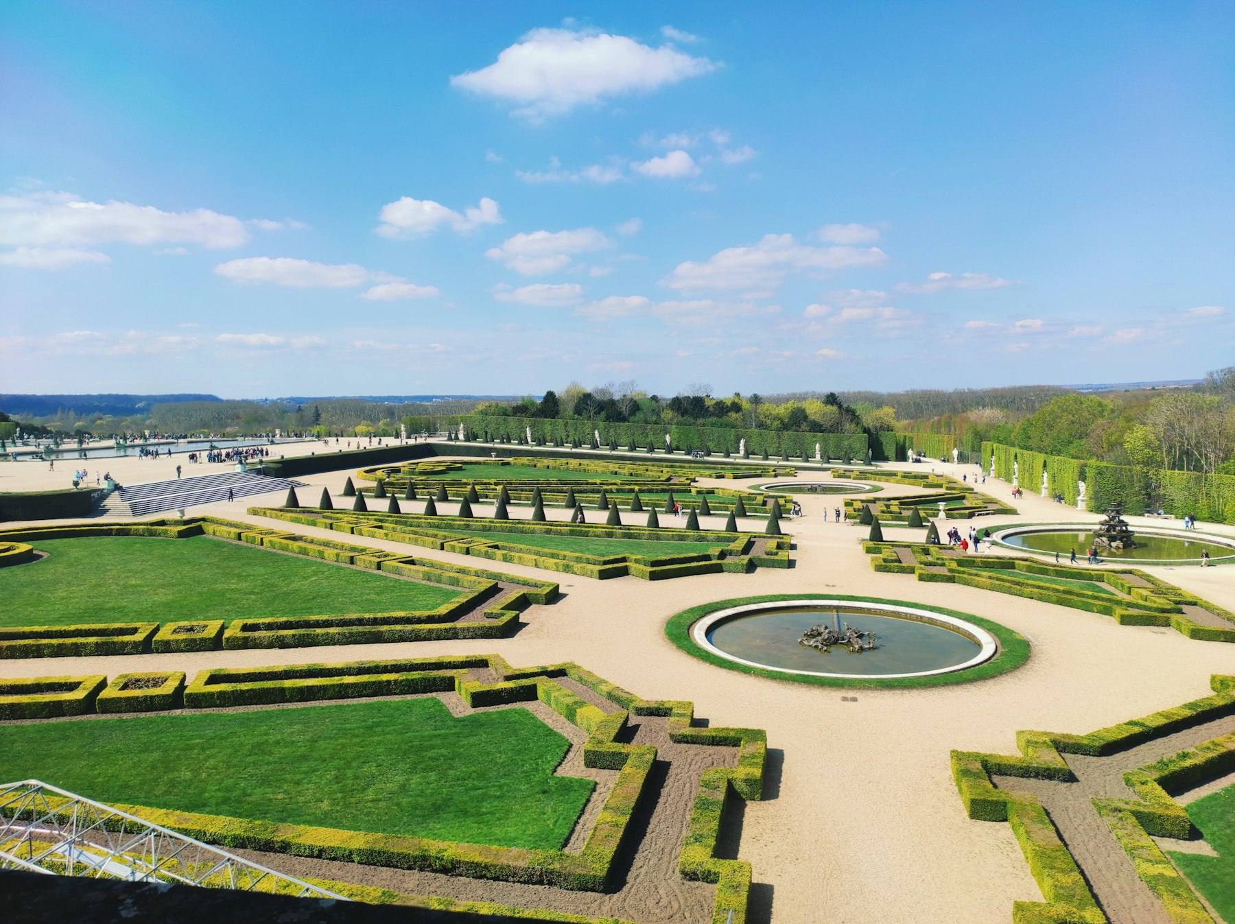 Formal gardens with a fountain surrounded by hedges at Versailles